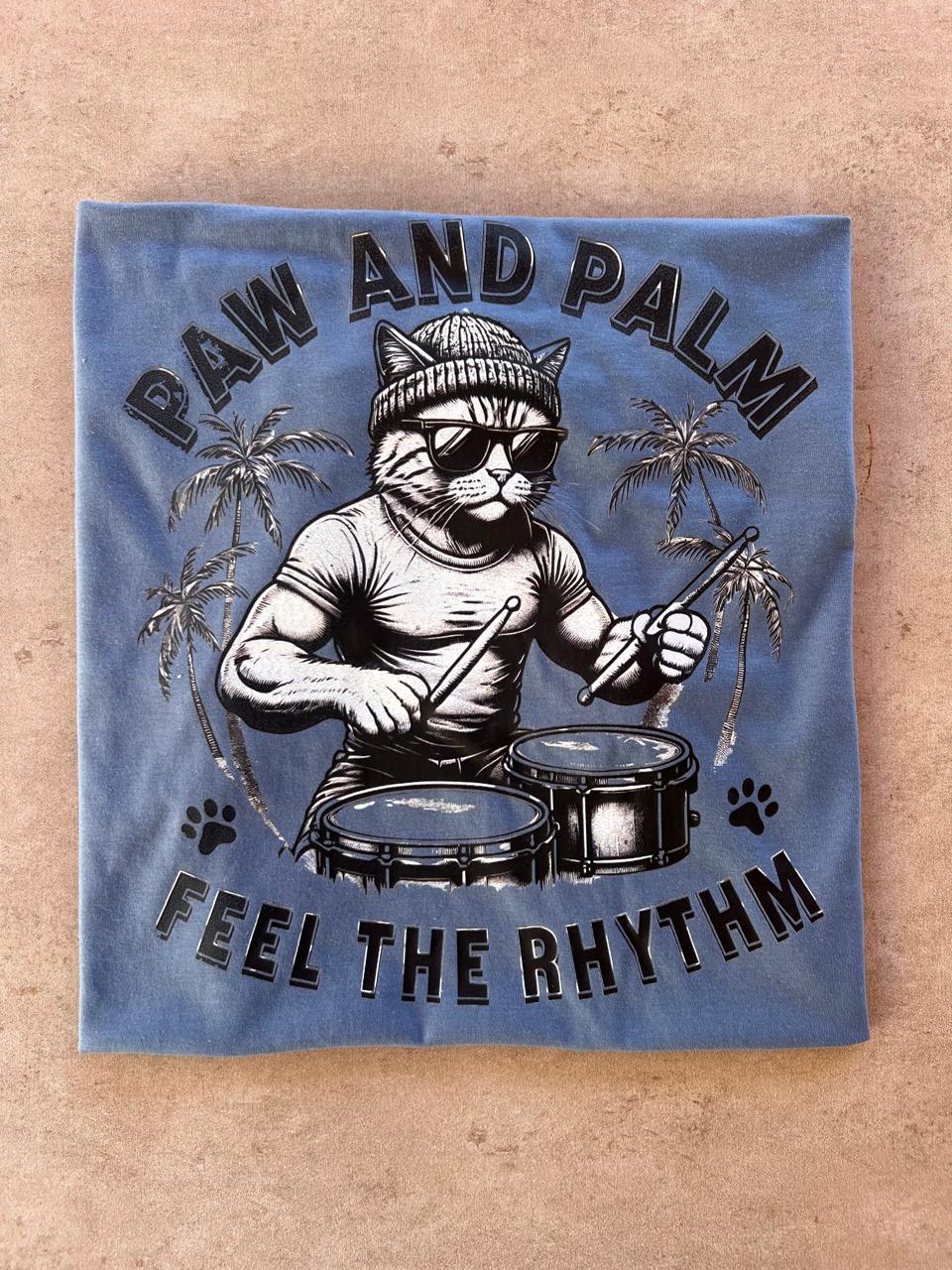 Paw and Palm t-shirt featuring a fun cat playing drums